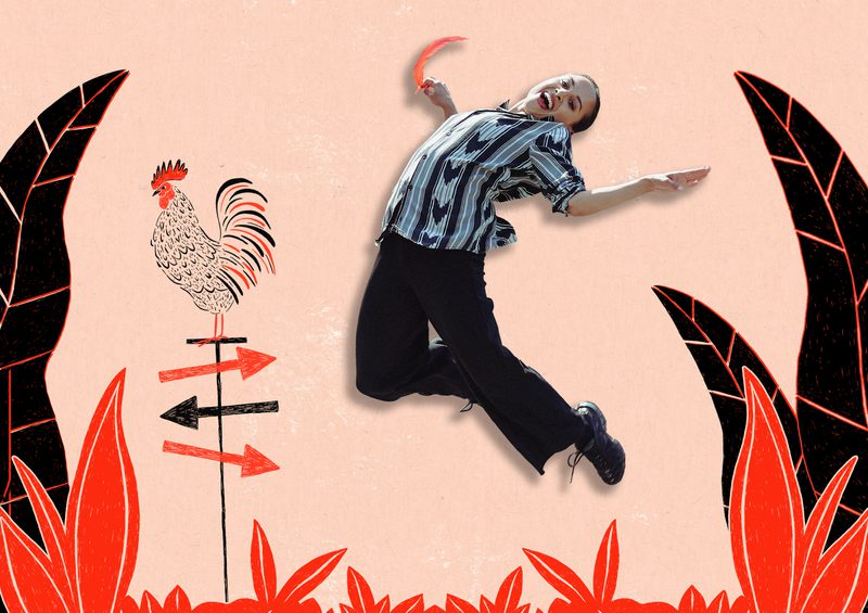 A performer appears mid-jump against an illustrated backdrop of red-and-black plants, with a rooster weather vane and directional arrows on the left side of the image.