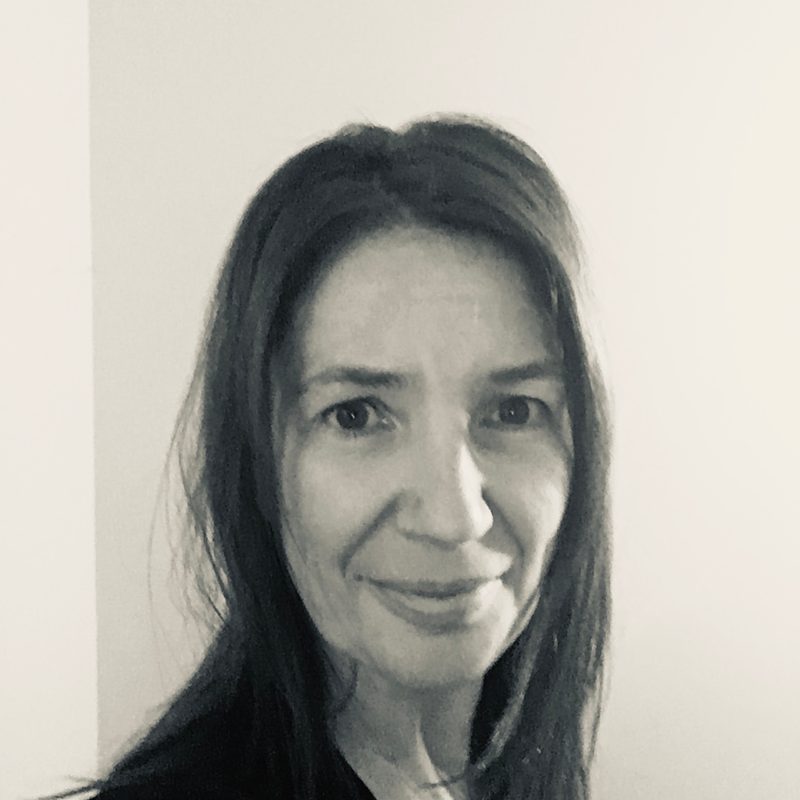 Black and white headshot of Andrea, a white woman
