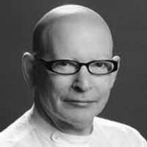 Image of Anthony van laast. Anthony wears thick glasses. This is a black and white image.