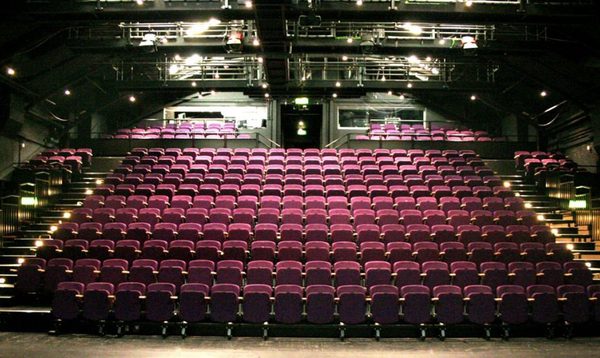 a photo of The Place theatre seats taken from the stage. The seats are purple and empty.