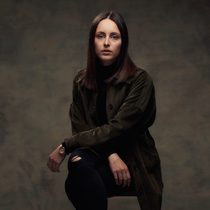 Margo's headshot against a dark backdrop