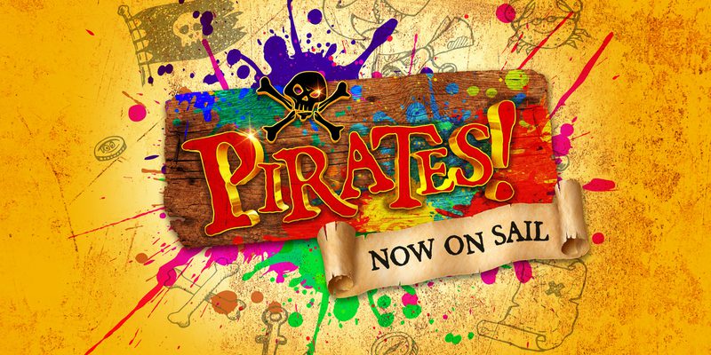 Text: Pirates! Now on Sail. Background is a treasure map splattered with fun paint colours, the text is bold red and mounted on a wooden plank, with 'Now On Sail' written on a scroll.