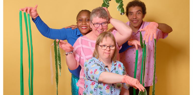 Four performer pose using gloves with Octopus Tentacles