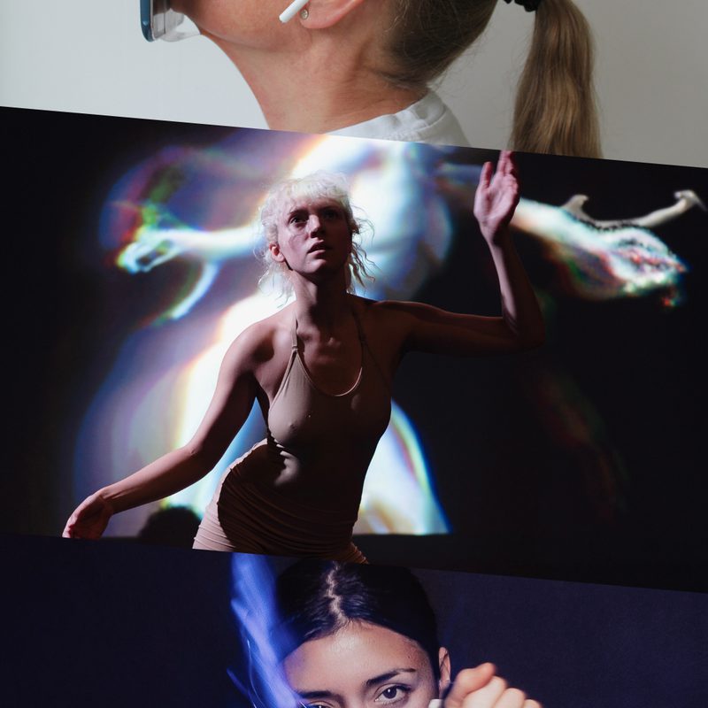 This image is divided into three parts. On the top, profile of a person with long grey hair tied in a ponytail, wearing a white T-shirt and white wireless headphones, looking upward with a row of mobile phones atop their face. In the centre, there is a person in a nude leotard, softly lit, poses with one leg bent and one arm raised, looking upward, a backdrop behind them displaying a light animation of a fantastical figure. On the bottom, person in a dark costume embellished with white ornaments, captured mid-motion, crossing their arms at chest-level, gazing forward and surrounded by a blue halo.