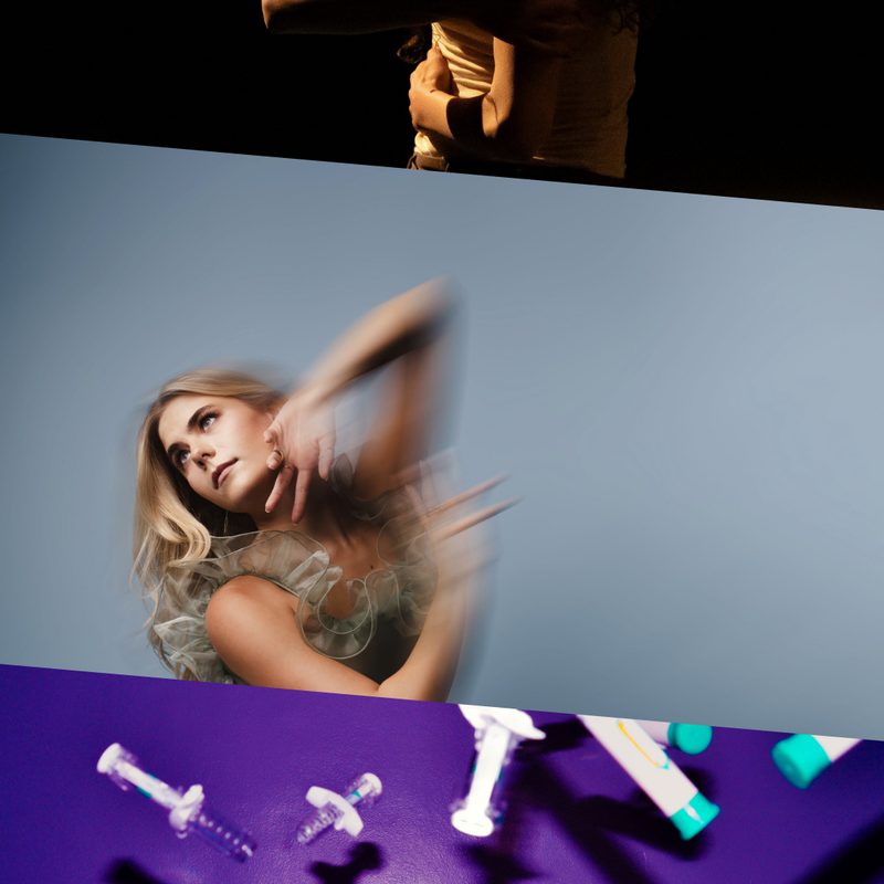 This image is divided into three parts. On the top, a woman with long hair, wearing a white tank top and dark trousers, is illuminated by low light as she wraps her arms around herself and curves her back. In the centre, a person in a grey dress with ruffled lining poses with arms raised, blurred from movement, leaning slightly backward and looking sideways against a light grey background. On the bottom, man shown from the shoulders up laughing against a purple background, surrounded by flying syringes.